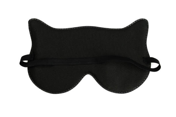 istock Black sleep mask cat with ears flat lay isolated on white 1356594692