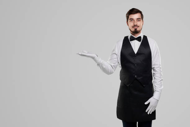 istock Friendly waiter in gloves on gray background 1356594737
