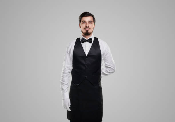 istock Bearded waiter in uniform on gray background 1356594743