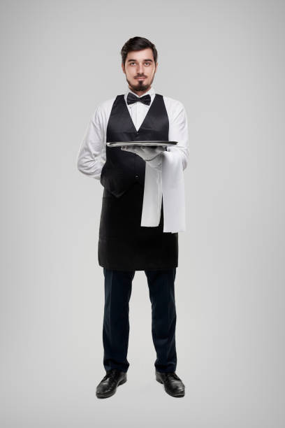 Waiter in black and white uniform with tray