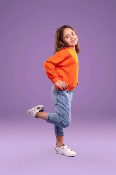 Photo of Playful little girl in trendy casual wear