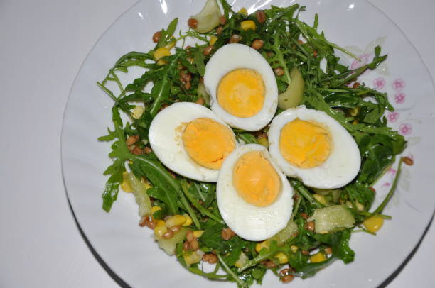 istock Boiled eggs sliced on arugula and pepper salad. Vegetarian meal. 1356599133