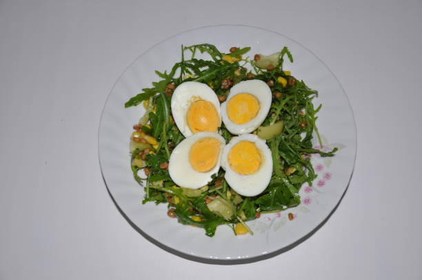 istock Boiled eggs sliced on arugula and pepper salad. Vegetarian meal. 1356599139