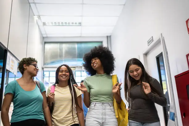 Photo of Teenage students talking at arriving at school