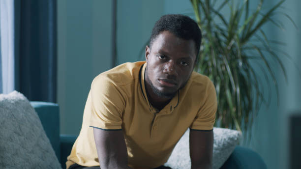 istock Sad African American man sitting on couch 1356601072