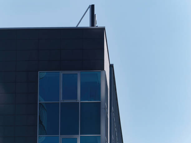 istock Daylight shot of a modern building with windows with a blue sky in the background 1356603421