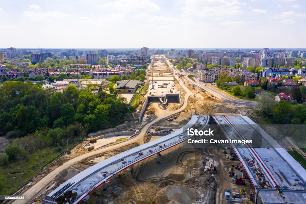 construction of new road at suburb area. aerial top view on indu construction of new road at suburb area. aerial top view on indu in Warsaw, Masovian Voivodeship, Poland Road Construction Stock Photo