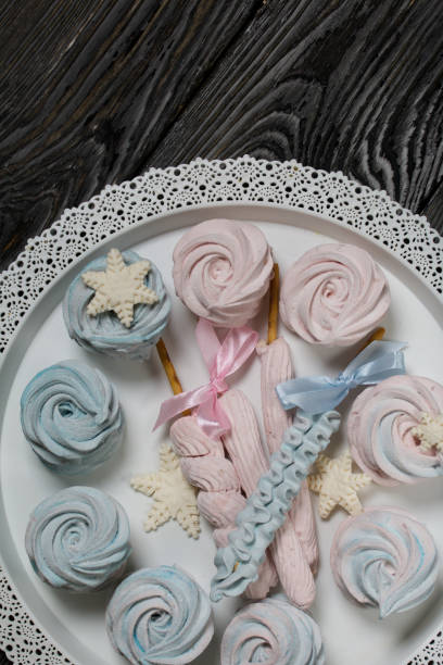 istock Marshmallow blue and pink. zephyr on a stick. Decorated with mastic snowflakes. 1356605816