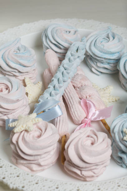 istock Marshmallow blue and pink. zephyr on a stick. Decorated with mastic snowflakes. 1356605822