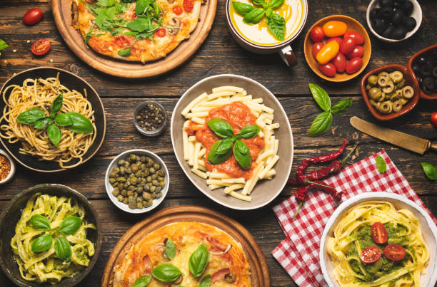 istock Italian food on dark background with pasta, pizza, top view, 1356606501