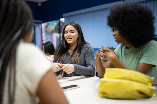 Teenage students talking in the classroom