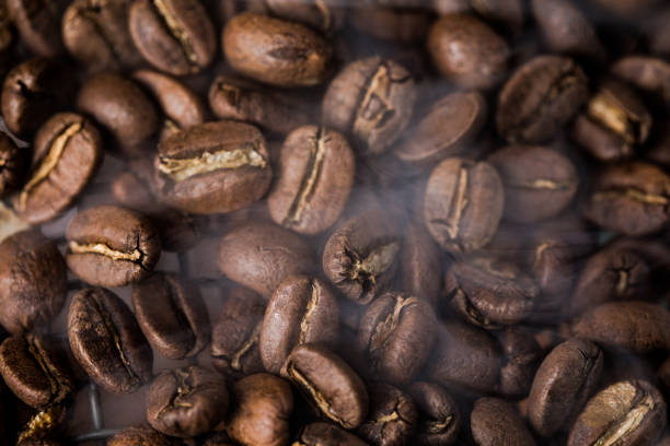 istock Coffee beans texture or coffee background. Fragrant fried bean  a-smoke. 1356607911