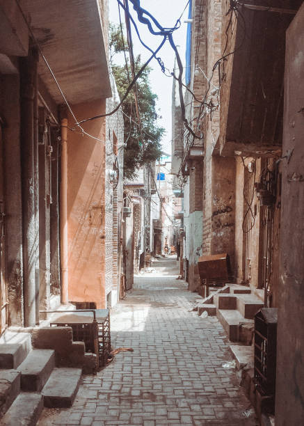 istock Narrow road, homes, structure, wires, dirty, roads, 1356613815