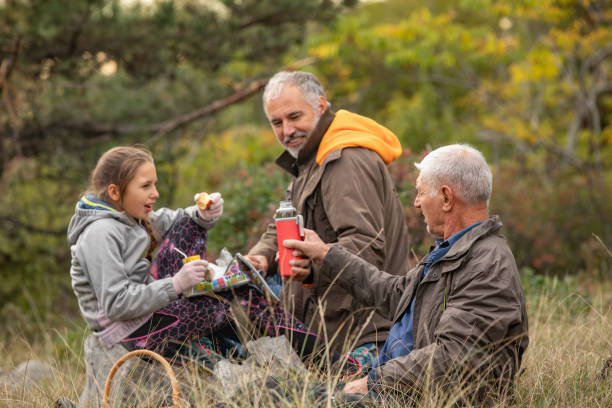 istock Family Having a Picnic Break in Nature 1356614607