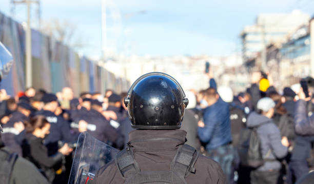 Riot police officer on duty during crowd protest or demonstration