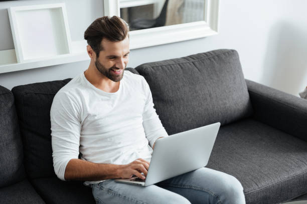 istock Cheerful young man sitting indoors at home 1356616326