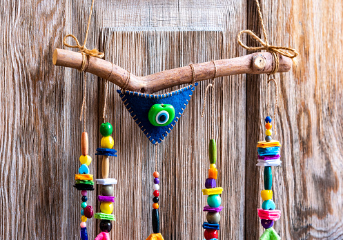 Colorful handmade evil eye beads hung on the door