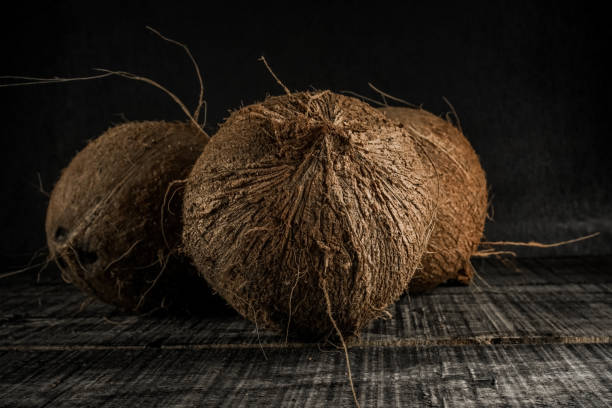 istock Uncoated old coconut fruit on a black background 1356618550