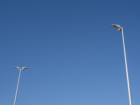 Street lamps with clear blue sky in the background and copy space. Urban and light concept