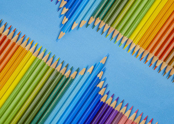 istock Closeup of colored pencils lined up in a row  and abstract shape on background copy space 1356619390