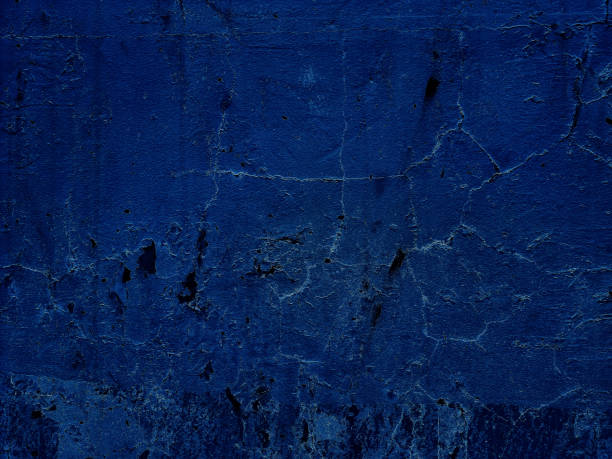 istock surface of blue weathered plaster concrete wall background. abandoned and distressed blue stucco wall texture background.  wall fragment with scratches and cracks. 1356619485