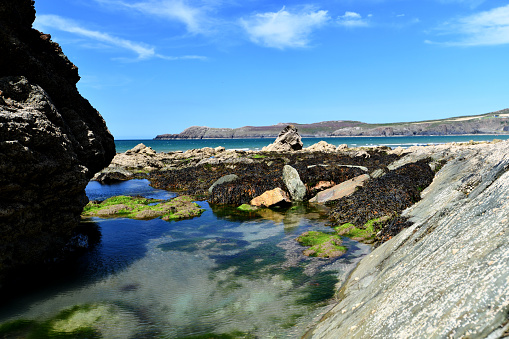 Wesh beach and coastline with rockpool in the foreground