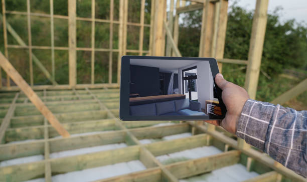 istock Man holding digital tablet with interior design images in construction site 1356620520
