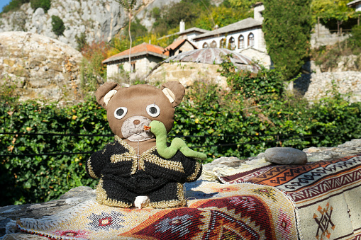 Počitelj, Čapljina municipality, Herzegovina Neretva Kanton, Federation of Bosnia and Herzegovina - October 2021: Teddy in front of old houses in Počitelj.