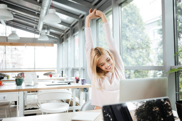 istock Happy lady sitting in office coworking while using laptop 1356621307