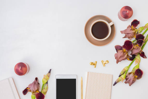 istock Flat lay composition with a cup of coffee and irises flowers on a white background 1356623728