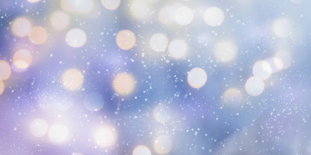 istock Abstract blue winter background with bokeh. Christmas light with falling snow. Winter panoramic scenery 1356623759
