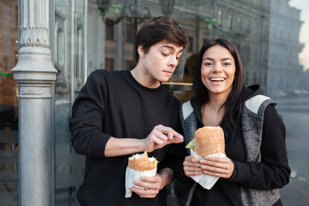 istock Brother trying to eat burger 1356623879