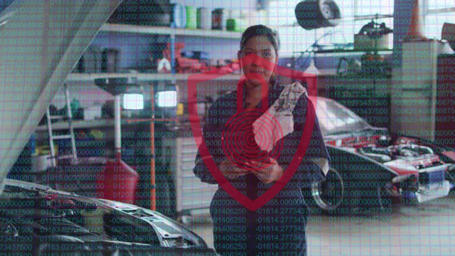 Animation of padlock and shield icon over biracial female car mechanic using tablet at garage