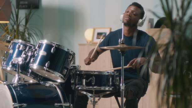 istock Black drummer playing energetic song 1356623966
