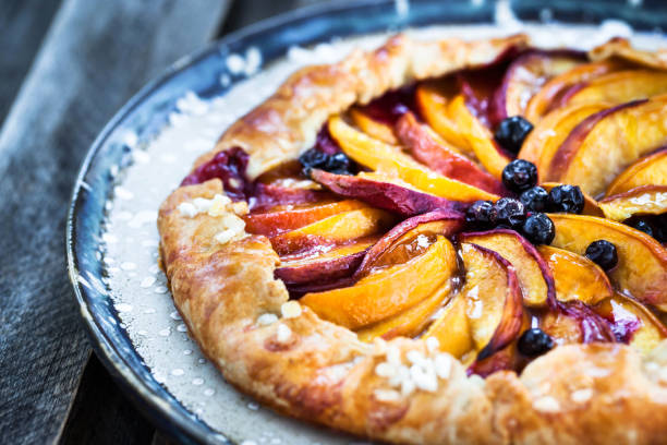 istock Rustic sweet open pie  with peach and berry 1356624152