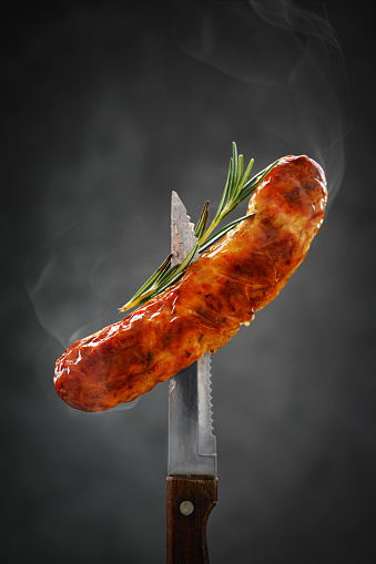 hot fried sausage on the knife