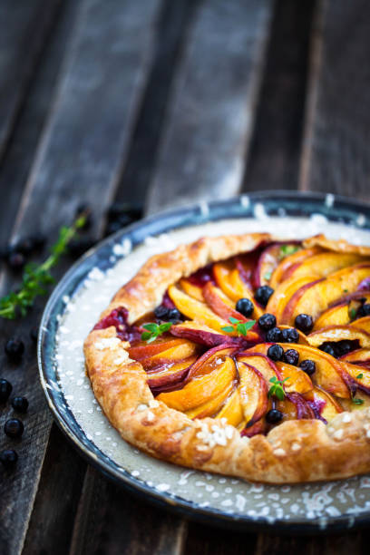 istock Rustic sweet open pie  with peach and berry 1356624339