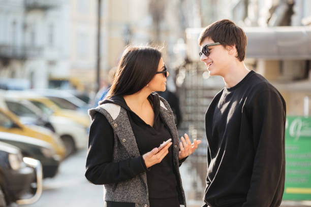 istock Woman walking outdoors with her brother. 1356625028