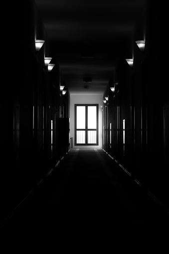 long dark corridor black and white photo of the hotel. vertical photo