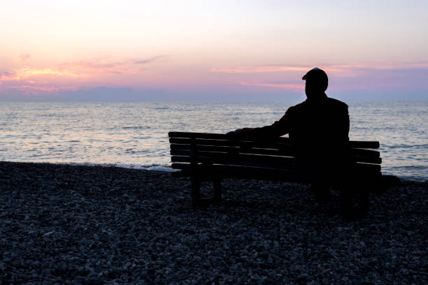 Free Stock Photo of Silhouettes sitting by the sea at sunset | Download ...