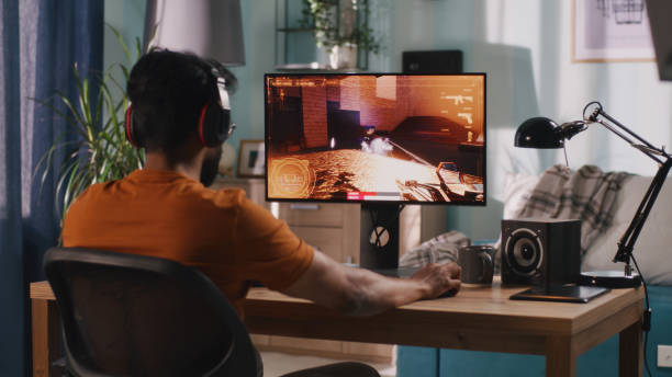 istock Indian gamer playing shooter at home 1356626246