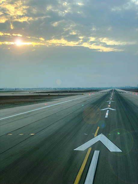 istock airplane runway with cloudy sky vertical photo 1356627429