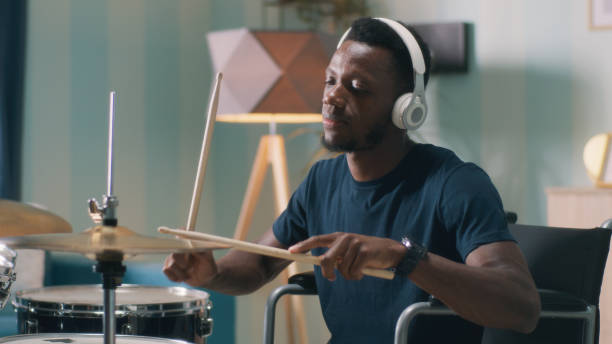 istock Handicapped African American man learning to play drums 1356628462
