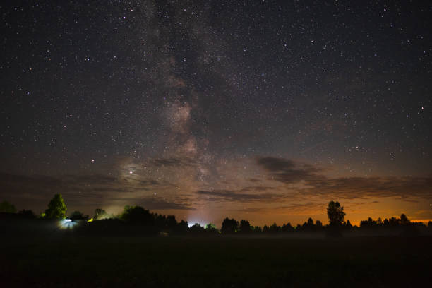 istock Night sky with milky way over the forest summer night 1356630288