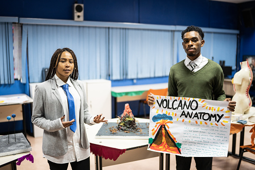 Teenage students presenting a school science online project in the classroom