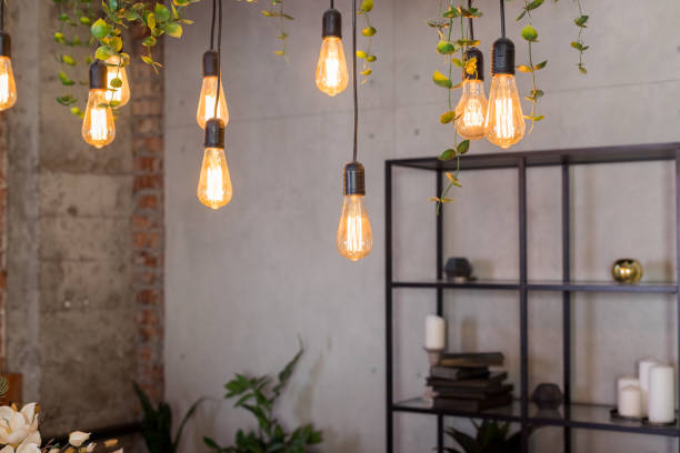 istock Restaurant decoration with edison bulbs.Retro style light bulbs .Electric lamp hanging from the ceiling. Cozy design, trendy interior. 1356630824