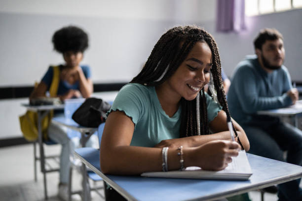 istock Teenage student writing in the classroom 1356630974