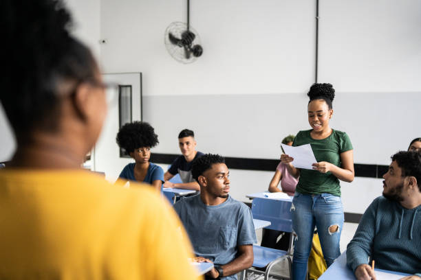 istock Teeange student reading aloud in the classroom 1356631105