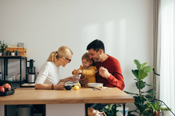 istock Family Time: Parents With Only Child Making Lemonade in the Morning 1356633057