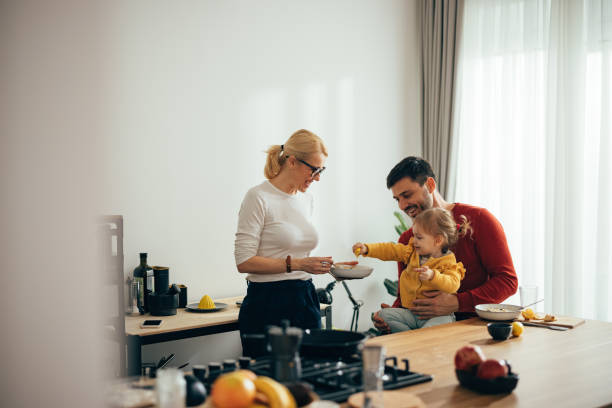 istock Family Time: Parents With Only Child Making Lemonade in the Morning 1356633058